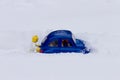 Man pushing car stuck in the snow. Toy models. Royalty Free Stock Photo